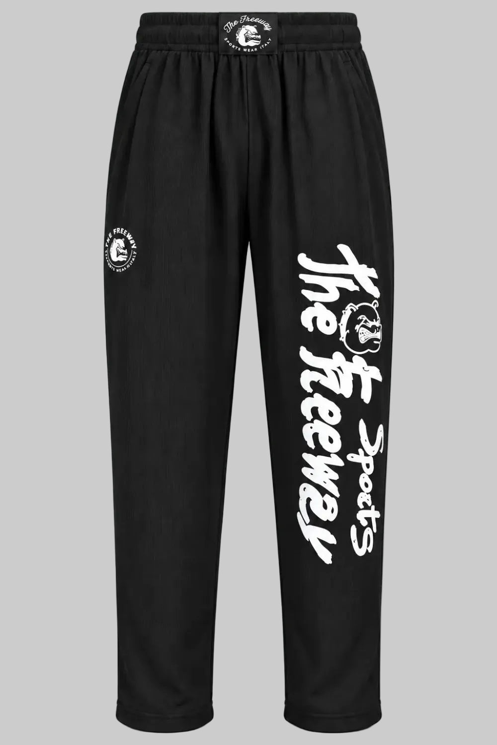 Unisex black bodybuilding training pants by Thefreeway Sportswear worn by a bodybuilder in the gym, front view with white leg logo