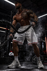 Men's white basketball shorts Thefreeway Sportswear art. 1503 worn by a bodybuilder training in the gym