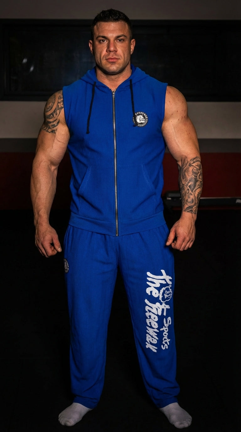 Unisex blue bodybuilding training pants Thefreeway Sportswear art. 252 worn by a bodybuilder with matching sleeveless hoodie, front view