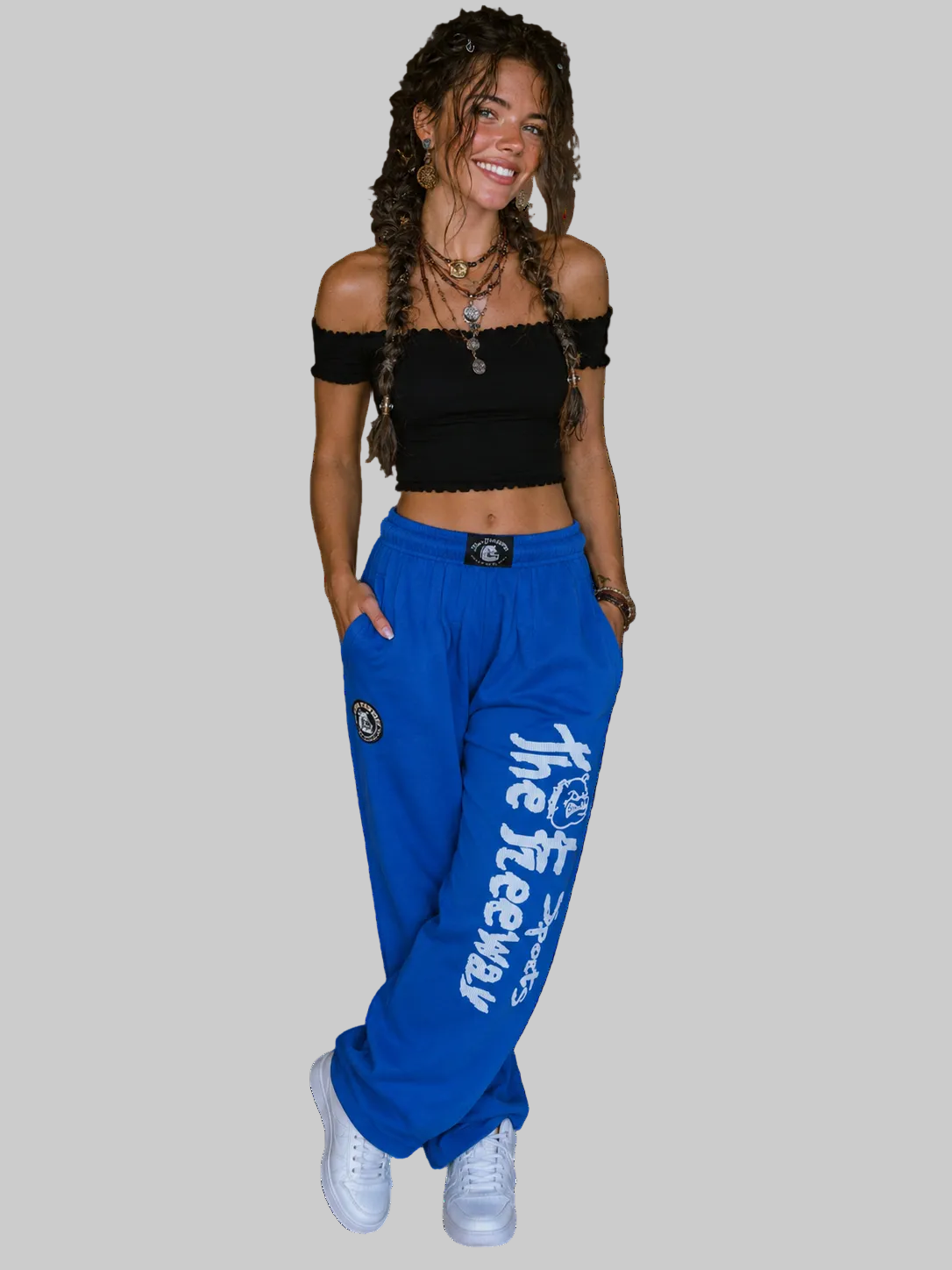Unisex blue bodybuilding training pants by Thefreeway Sportswear worn by a model in a casual front pose with white leg logo