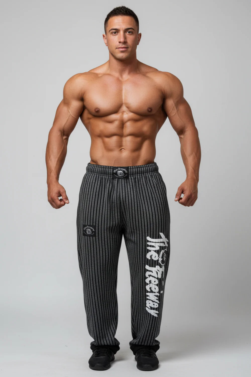 Thefreeway Art.253 unisex bodybuilding training pants in grey and black stripes, front view worn by a male bodybuilder in studio