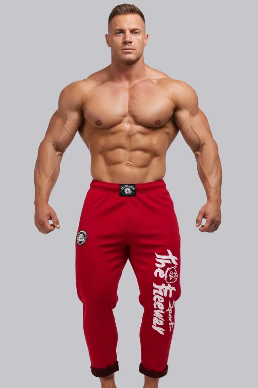 Thefreeway Art.254 unisex bodybuilding training pants in red and black stripes worn by a male bodybuilder in a relaxed front pose