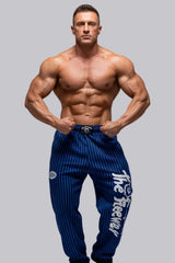 Thefreeway Art.253 unisex bodybuilding training pants in royal blue and black stripes worn by a male bodybuilder in a front bodybuilding pose