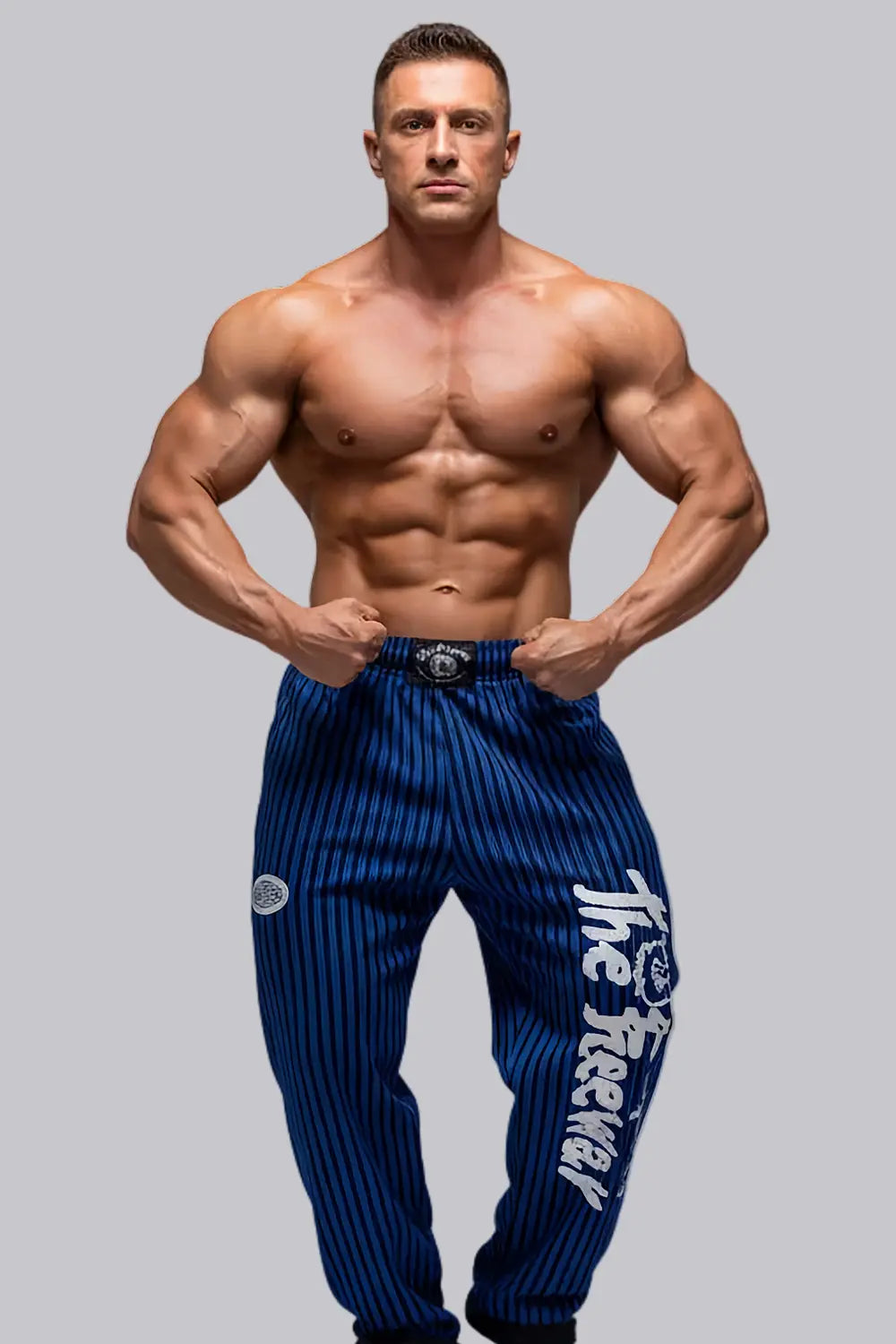 Thefreeway Art.253 unisex bodybuilding training pants in royal blue and black stripes worn by a male bodybuilder in a front bodybuilding pose