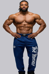 Thefreeway Art.253 unisex bodybuilding training pants in royal blue and black stripes, front view worn by a male bodybuilder
