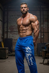 Thefreeway Art.254 unisex bodybuilding training pants in sky blue and black stripes worn by a male bodybuilder in a three-quarter gym view