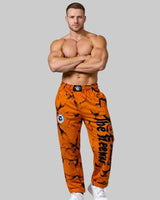 Unisex mustard marbled bodybuilding training pants by Thefreeway Sportswear worn by a bodybuilder with crossed arms, front view