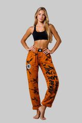 Unisex mustard marbled bodybuilding training pants by Thefreeway Sportswear worn by a female model in a front pose with black leg logo