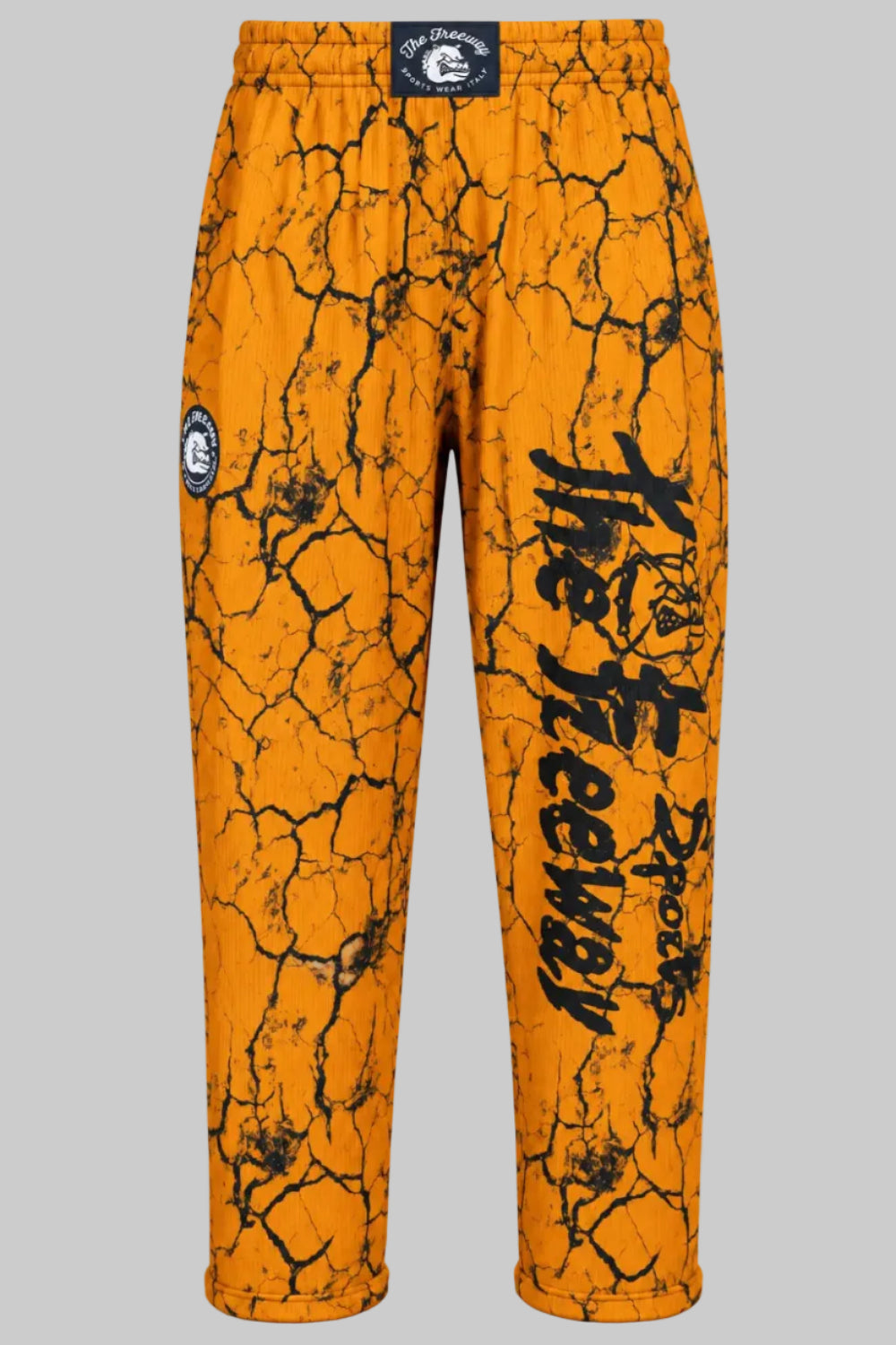Unisex mustard marbled bodybuilding training pants by Thefreeway Sportswear worn by a female model, front view with black leg logo