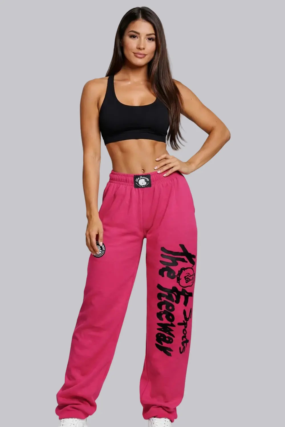 Thefreeway unisex training pants in fuchsia worn by a female model, full-body front view