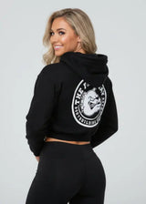 Thefreeway Art.7870 women's black training suit hooded jacket worn by a female model, three-quarter back view showing the large rear logo
