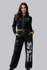 Thefreeway Art.7870 women's training suit in marbled black worn by a female model, full-body front studio view