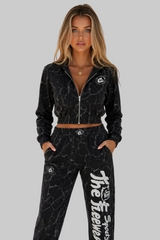 Thefreeway women's training suit in marbled black worn by a female fitness model, front view